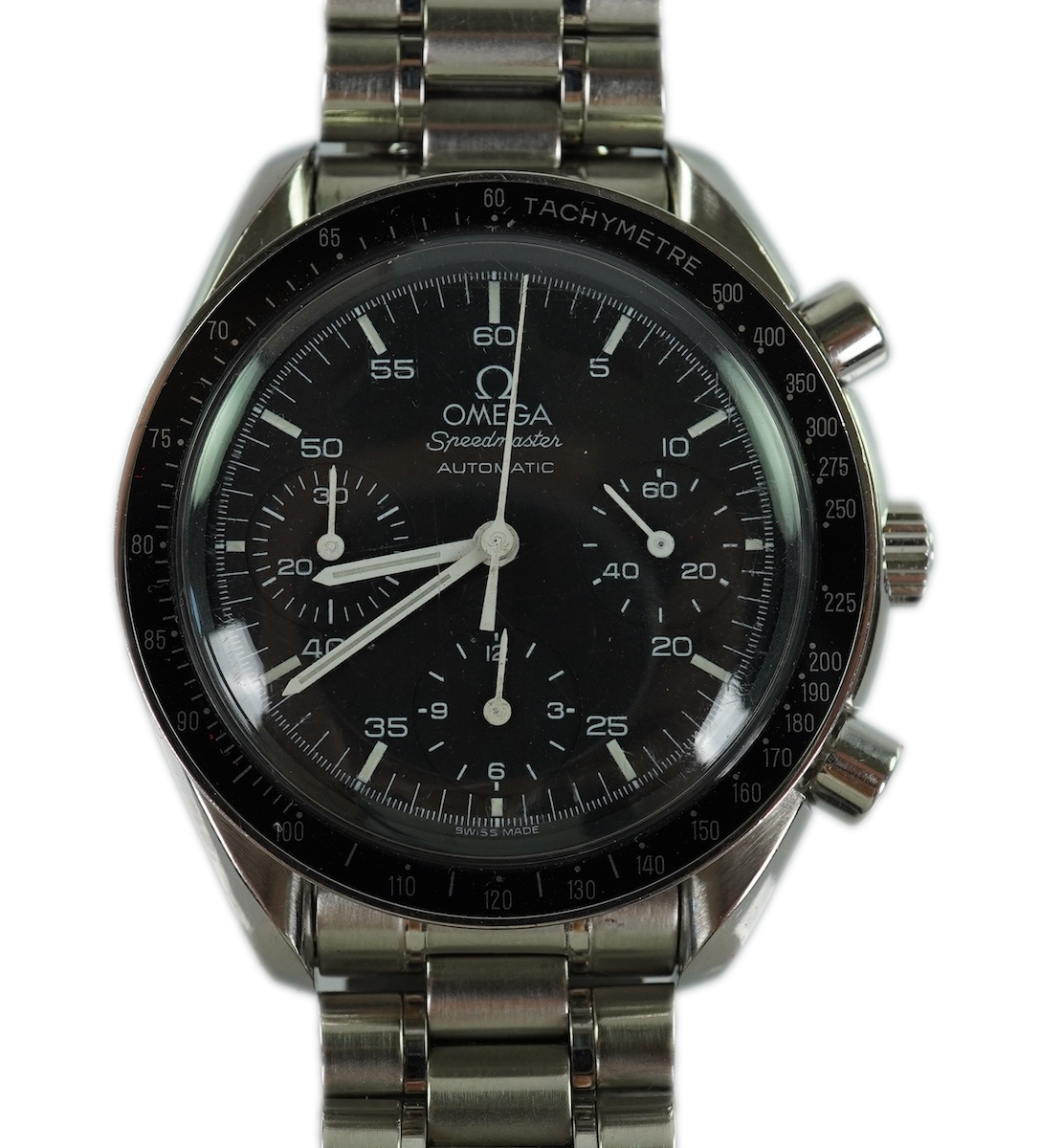 A gentleman's late 1990's stainless steel Omega Speedmaster automatic wrist watch, with box and three pamphlets